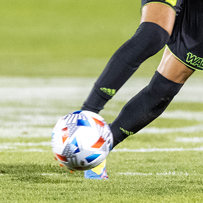 male player kicking soccer ball