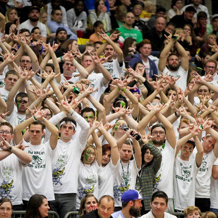 Shows the entire basketball court in the UCCU center during a game with fans in the stands.